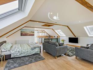 a bedroom with a bed and two chairs and a tv at 1 Bed in Launceston oc-86674 in North Petherwin +15 photos