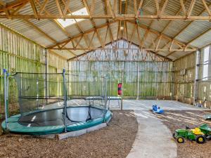 a large metal barn with a trampoline in it at 3 Bed in Bude oc-corym in Morwenstow
