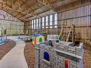 a large building with a play room with toys in it at 3 Bed in Bude oc-corym in Morwenstow