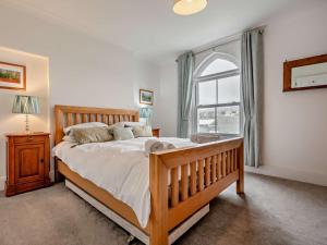 a bedroom with a large bed and a window at 3 Bed in Newquay oc-53688 in Newquay