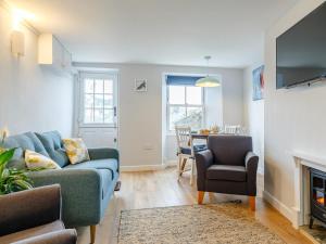 a living room with a couch and a table at 2 Bed in Polruan oc-82949 in Fowey
