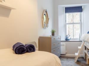 a bedroom with a bed with two towels on it at 2 Bed in Polruan oc-82949 in Fowey