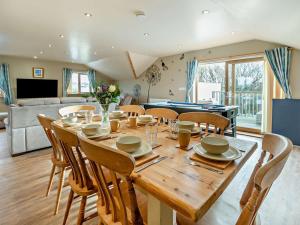 a dining room and living room with a table and chairs at 4 Bed in Newquay oc-56747 in Cubert