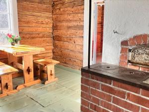 a patio with a table and a brick fireplace at Ahtelan torppa 2 in Salo