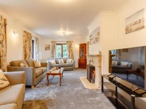 a living room with couches and a fireplace at 4 Bed in Bodmin oc-88543 in Bodmin
