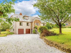 a house with a garage on a gravel driveway at 4 Bed in Bodmin oc-88543 in Bodmin