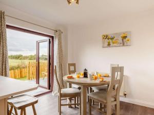 a kitchen and dining room with a table and chairs at 4 Bed in Bodmin oc-88543 in Bodmin