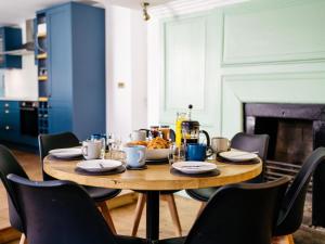 a dining room table with chairs and food on it at 8 Bed in Newquay oc-81510 in Saint Columb Major