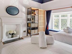 a bedroom with two beds and a book shelf at 8 Bed in Newquay oc-81510 in Saint Columb Major