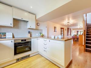 a kitchen with white cabinets and a stove top oven at 3 Bed in Launceston oc-oldoa in North Hill +26 photos