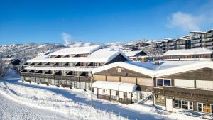 a resort in the snow with snow covered buildings at Bergo Leiligheter in Beitostøl +9 photos