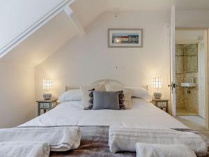 a bedroom with a large white bed with two pillows at 2 Bed in Looe oc-82537 in Looe