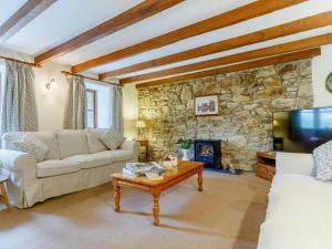 a living room with a couch and a fireplace at 2 Bed in St. Austell oc-82609 in St Austell