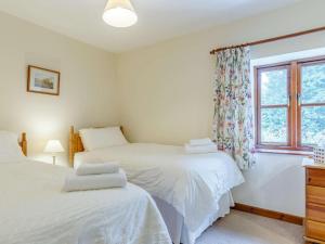 two beds in a bedroom with a window at 2 Bed in St. Austell oc-82609 in St Austell