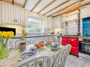 a kitchen with a table with a bowl of fruit on it at 3 Bed in Padstow oc-treba in Saint Merryn