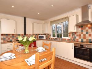 a kitchen with a wooden table and a dining room at 2 Bed in Wadebridge oc-51925 in Egloshayle