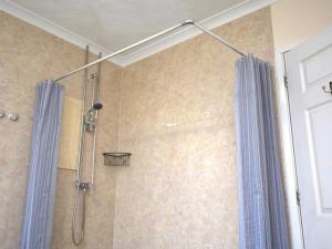 a shower with a blue shower curtain in a bathroom at 2 Bed in Wadebridge oc-51925 in Egloshayle +15 photos