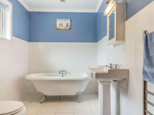 a bathroom with a white tub and a sink at 2 Bed in Falmouth oc-tvean in Constantine +17 photos