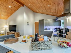 a kitchen and living room with a table with food on it at 3 Bed in St. Columb oc-43079 in Saint Columb Major
