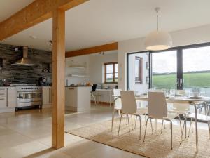 a kitchen and dining room with a table and chairs at 3 Bed in Crackington Haven oc-78271 in Saint Gennys