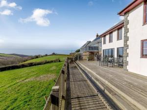 a house with a wooden deck with a view of the ocean at 3 Bed in Crackington Haven oc-78271 in Saint Gennys