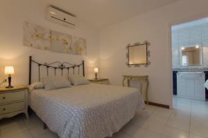 a bedroom with a bed and a mirror on the wall at Villa Corona in Puerto del Carmen