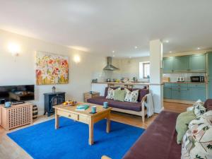 a living room with a couch and a table at 3 Bed in Bridport oc-dc049 in Chideock