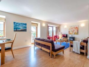 a living room with a couch and a table at 3 Bed in Bridport oc-dc049 in Chideock