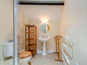 a bathroom with a toilet and a sink at 3 Bed in Bridport oc-dc049 in Chideock +25 photos