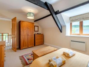 a bedroom with a large bed and a window at 3 Bed in Bridport oc-dc049 in Chideock