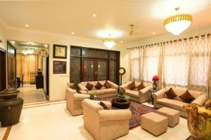 a large living room with couches and a table at Palm 34 in Jaipur