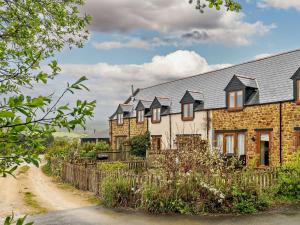 a row of brick houses on a dirt road at 3 Bed in Bridport oc-dc087 in Chideock