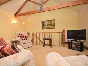 a living room with two couches and a flat screen tv at 2 Bed in Bodmin oc-chest in Lanlivery