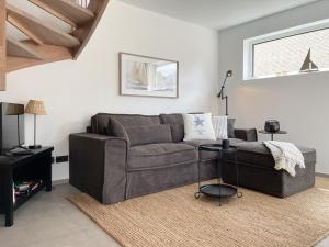 a living room with a couch and a table at Hygge Hus 1 in Timmendorfer Strand +32 photos