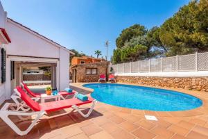 a swimming pool with two lounge chairs and a table and a pool at Villa Rincon by Villa Plus in Cala Blanca