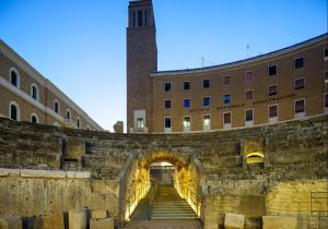 a stairway leading to a building with a tower at Dimora Novecento Lecce in Lecce