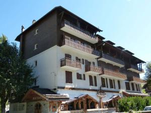a large building with balconies on the side of it at Appartement au cœur de La Clusaz, animaux acceptés - FR-1-304-7 in La Clusaz