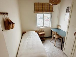 a small bedroom with a bed and a desk at Casa Tajo in Tarifa