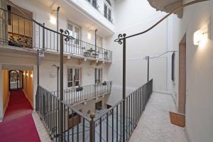 a hallway with a staircase in a building at Downtown Apartment - Gardagate in Salò