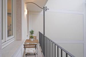 a stairway with a bench and a lamp at Downtown Apartment - Gardagate in Salò