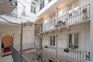 a building with two balconies with plants on them at Downtown Apartment - Gardagate in Salò