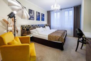 a hotel room with a bed and a chair at Hotel Aplaus in Litomyšl