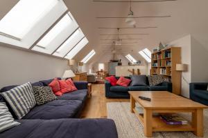 a living room with two couches and a table at Juniper Cottage - Elie in Elie