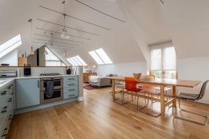 a kitchen and dining room with a wooden table at Juniper Cottage - Elie in Elie