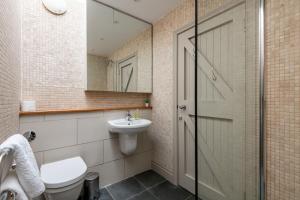 a bathroom with a toilet and a sink and a mirror at Juniper Cottage - Elie in Elie +19 photos
