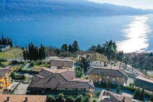 an aerial view of a house and the water at La Portella - Gardagate in Tignale +25 photos
