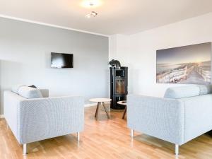 a living room with two chairs and a table at Loft in Timmendorfer Strand