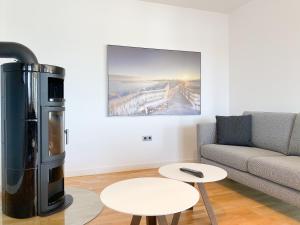 a living room with a couch and a large refrigerator at Loft in Timmendorfer Strand +30 photos