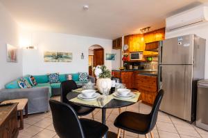 a kitchen and living room with a table and chairs at GhadiraBay seafront with sea views by Homely in Mellieħa