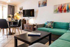 a living room with a couch and a table at GhadiraBay seafront with sea views by Homely in Mellieħa